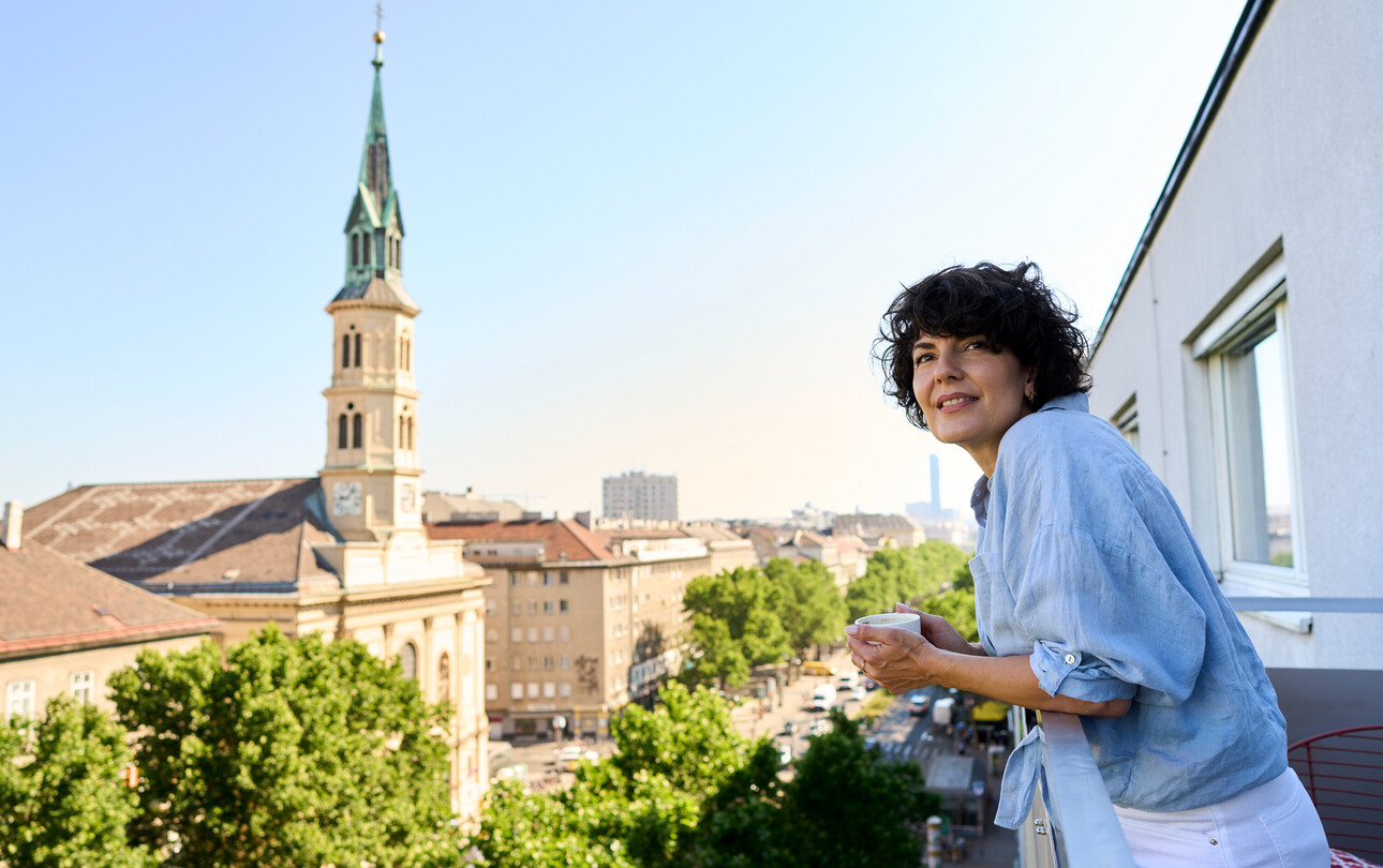 Lady on the balcony of the Hotel Henriette near the Messe Wien Exhibition & Congress Center.