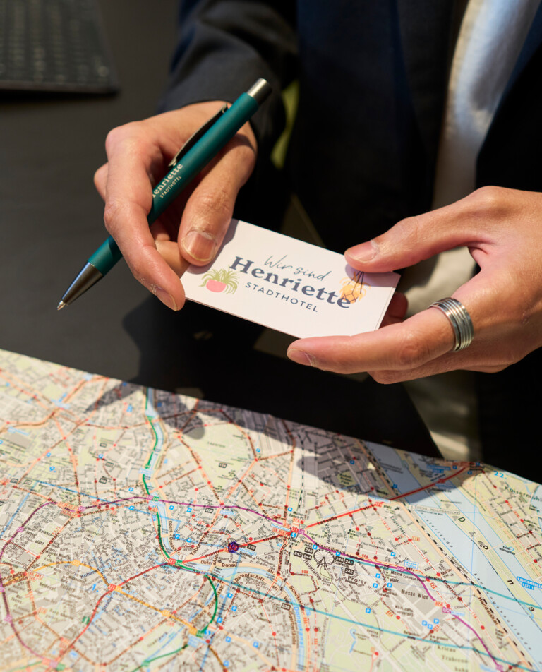 Host marks the location of the Hotel Henriette on a map of Vienna.