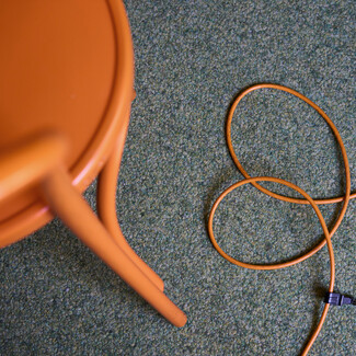 Orange chair and cable in Hotel Henriette, Vienna.
