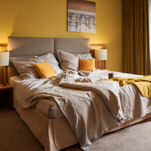 A double bed in a hotel room at the Hotel Henriette