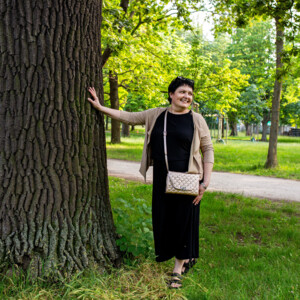 An employee of the city hotel Henriette sitting on a park bench during a trip to the Danube Island in Vienna.