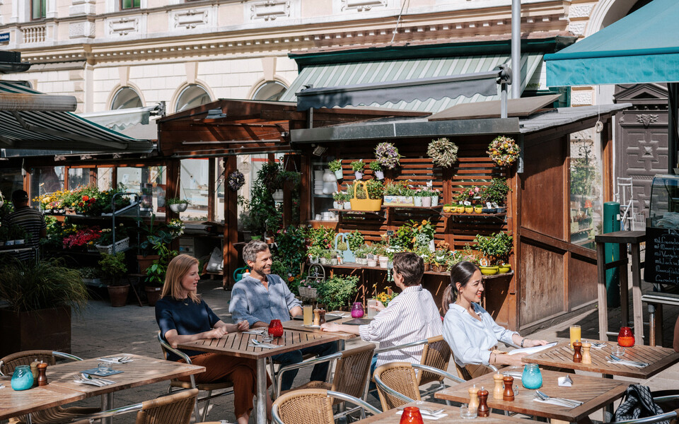 People sit in a café in Vienna Leopoldstadt.