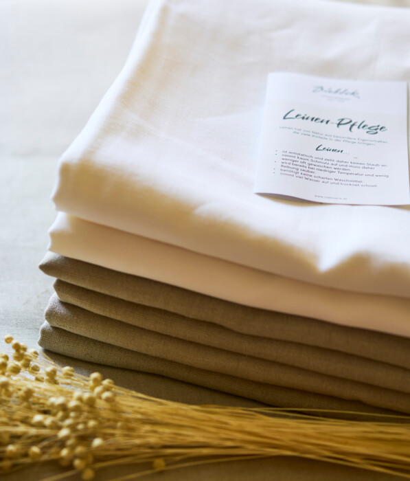 Stack of bed sheets made of organic cotton and organic linen at Hotel Henriette