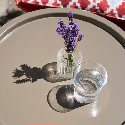 Vase with lavender and water glass on a table in the Boutique Hotel Henriette in Vienna.