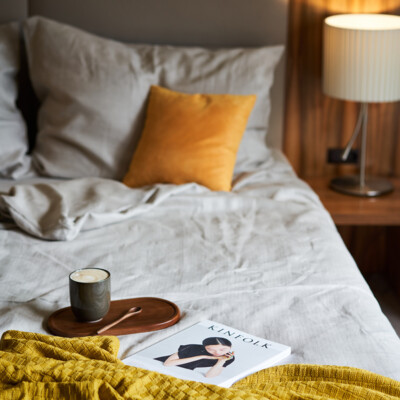 Double bed with a coffee and book at the 4-star Hotel Henriette in Vienna.
