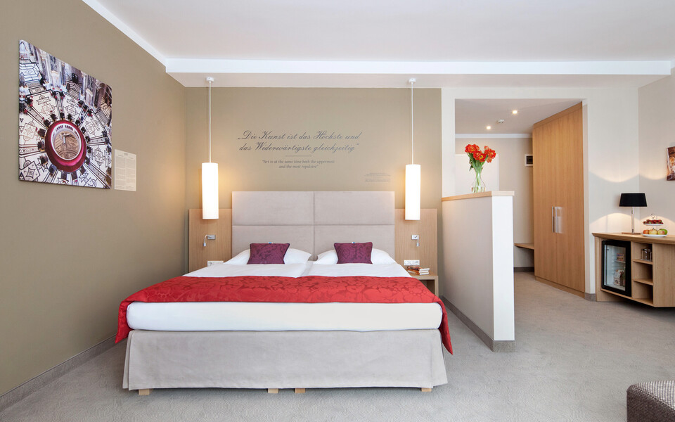 Large family suite with a king-size bed at hotel Henriette in Vienna downtown .