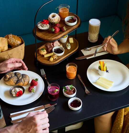 Laid table with breakfast, pastries, juices in the Boutique Hotel Henriette in Vienna.