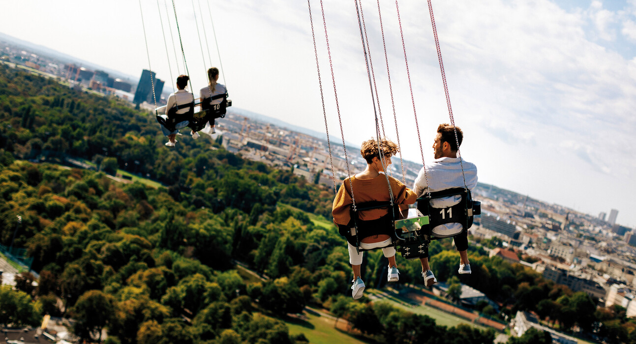 Couples on the chair swing in Vienna's Prater.
