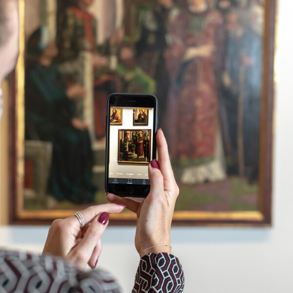 Woman photographs a painting at the Upper Belvedere in Vienna.