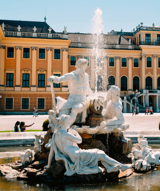 Fountain in front of Vienna's Schönbrunn Palace in summer.
