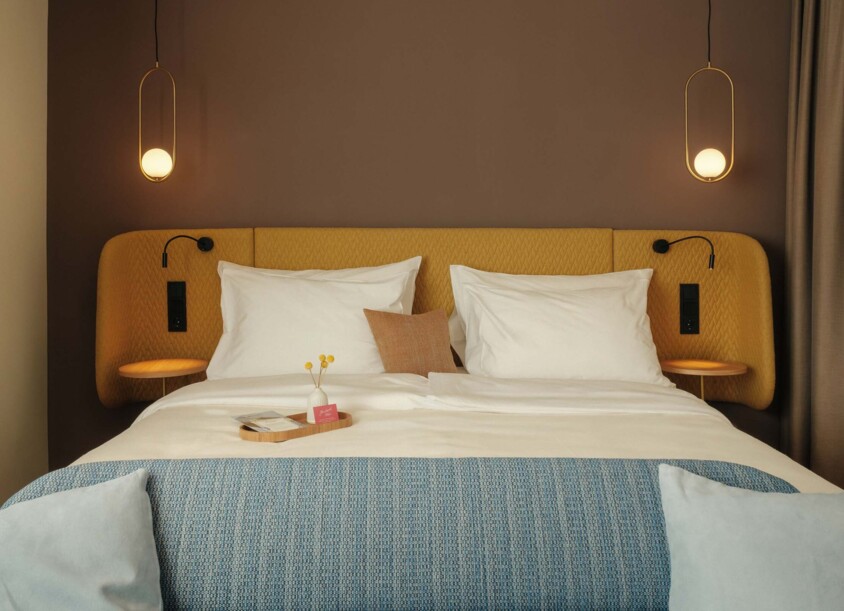 Cozy double bed in a Circular Living room at Hotel Henriette in Vienna.