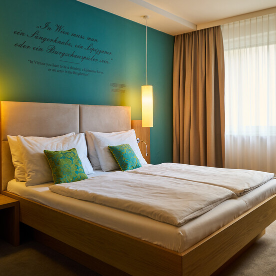 Large double bed in the 4-star Boutique Hotel Henriette in Vienna.