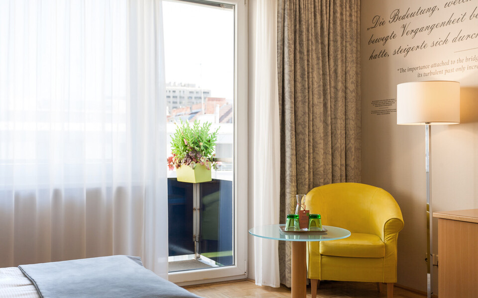 Gemütliche Sitzmöglichkeit im großzügigen Superior Doppelzimmer mit Balkon im Henriette Stadthotel.