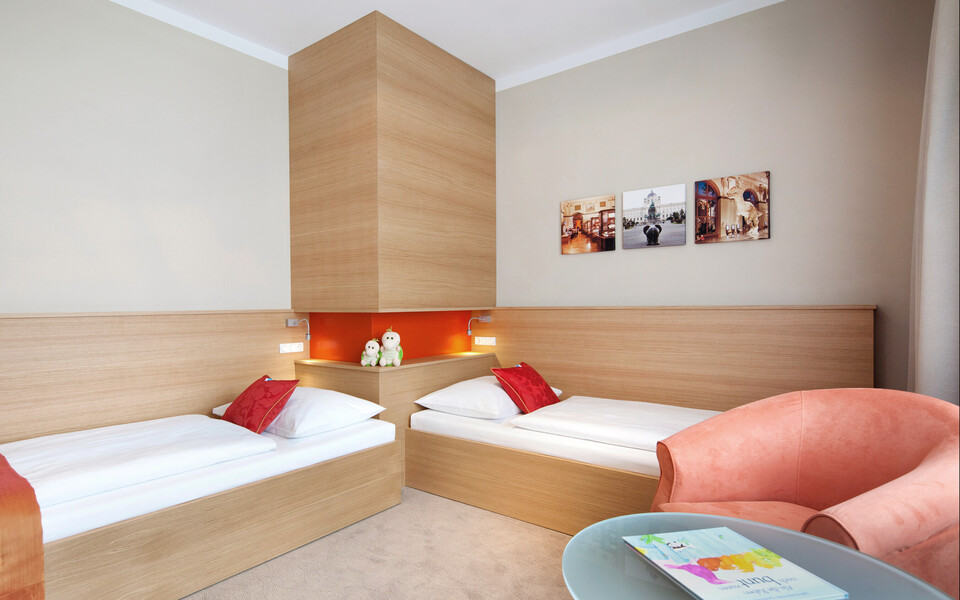 Children's room with separate beds in the family suite at hotel Henriette in Vienna.