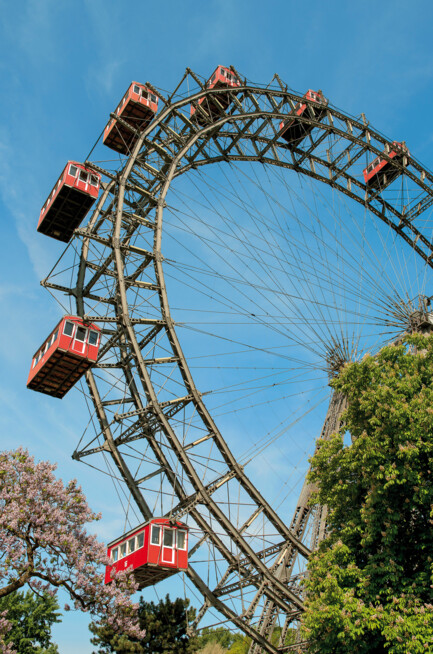 Vienna Giant Ferris Wheel with red cabins on a sunny spring day.