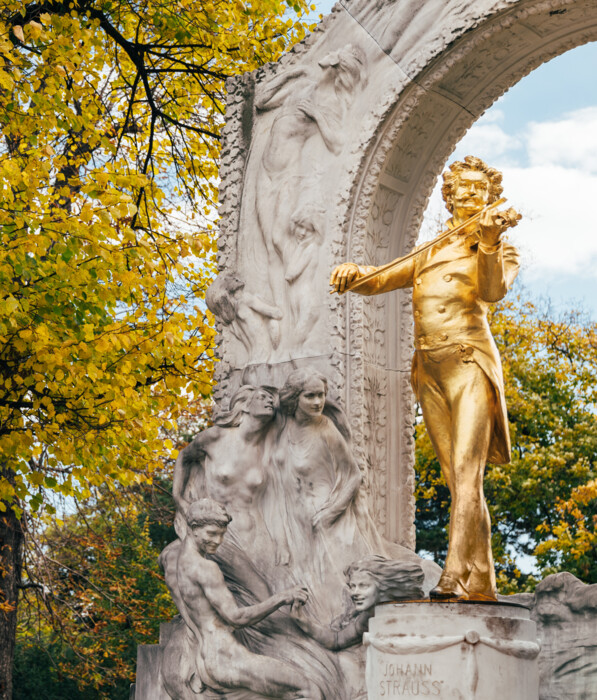 Die berühmte goldene Strauss-Statue umgeben von goldenem Herbstlaub im Wiener Stadtpark