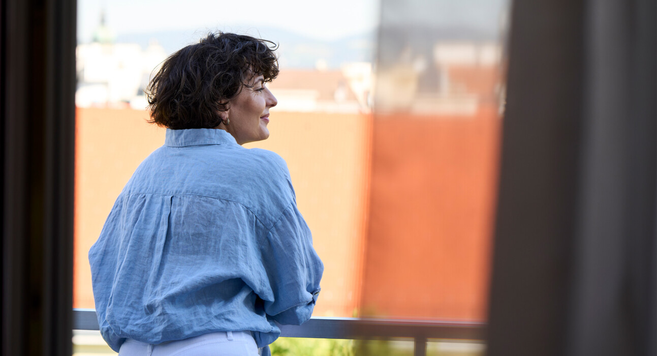 Woman enjoying the view from the balcony of Hotel Henriette in Vienna.