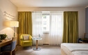 Modernes Superior Doppelzimmer mit Sitzgelegenheit und Schreibtisch im Henriette Stadthotel, Wien.
