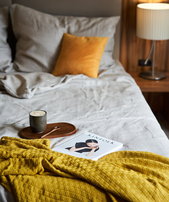 Double bed with a coffee and book at the 4-star Hotel Henriette in Vienna.