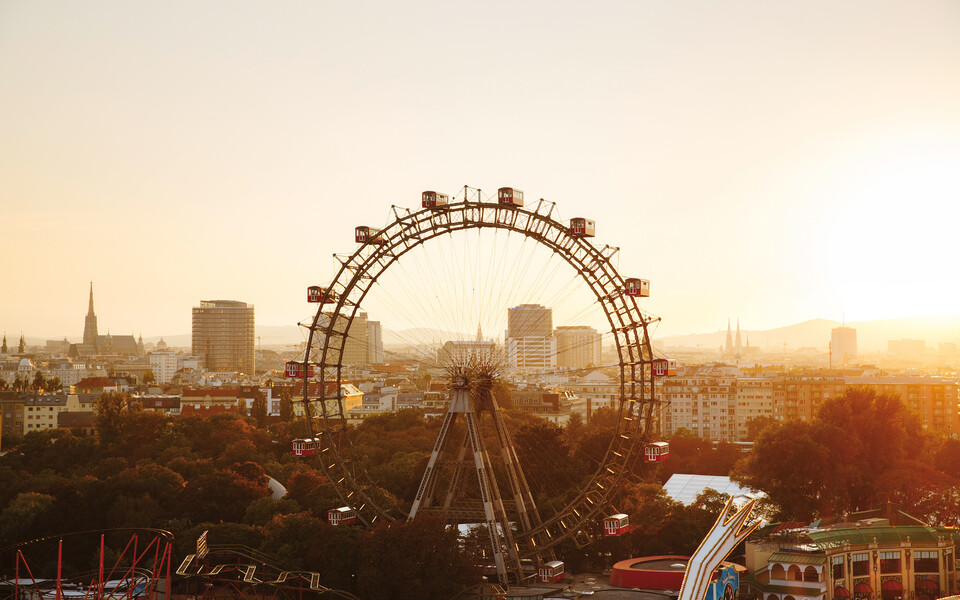 The famous Ferris wheel in Vienna at sunset with a view of the city.