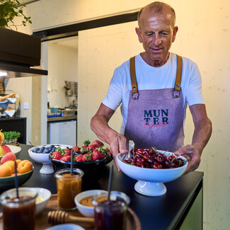 Employees of the Boutique Hotel Henriette in Vienna with fresh cherries at the breakfast buffet.