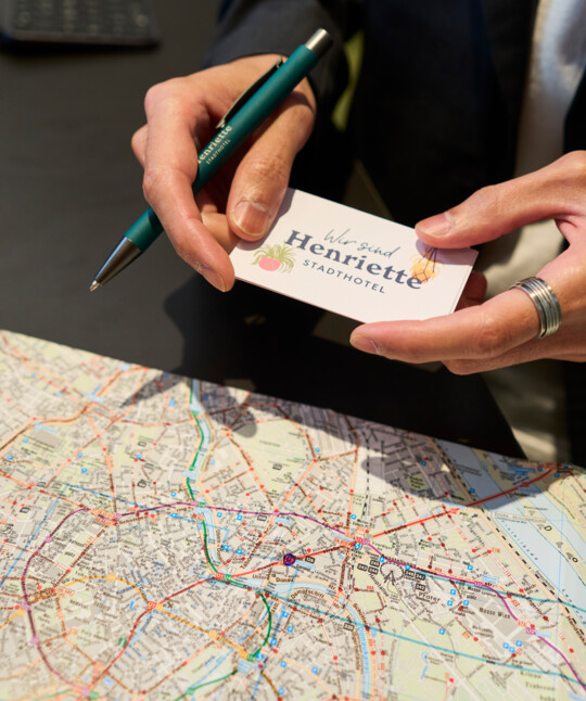 Host marks the location of the Hotel Henriette on a map of Vienna.