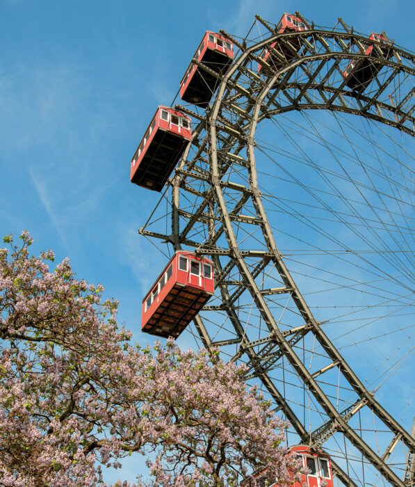Vienna Giant Ferris Wheel with red cabins on a sunny spring day.