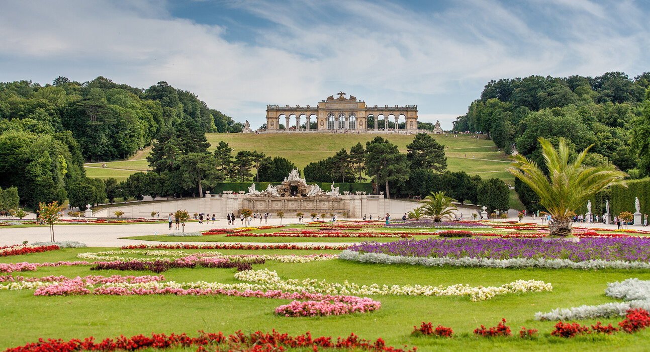 Spring in Vienna brings colour to the city: the Gloriette at Schönbrunn Palace amidst colourful flowerbeds in the fresh green palace park